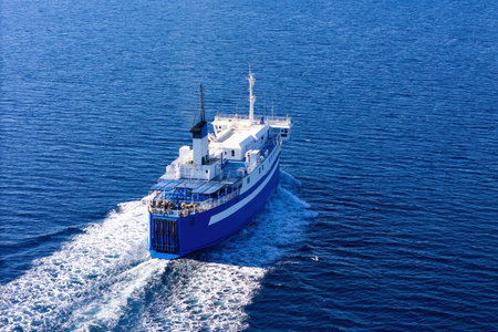 Ferry on open water cruising between Greek islands. Drone camera follows shipの写真素材