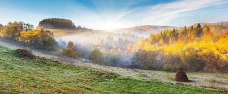 Majestic morning mountain landscape with colorful forest and blue sky. Autumn leaves. Carpathian, Ukraine, Europe. Beauty world.の写真素材