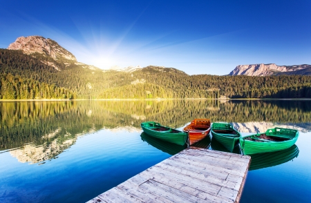 Reflection in water of mountain lakes and boats. Black lake in Durmitor national park in Montenegro, Europe. Beauty world.の写真素材