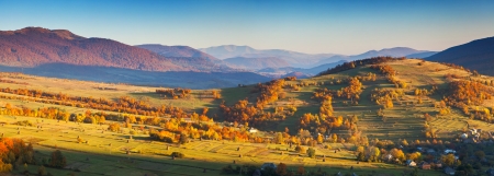 Majestic morning mountain landscape with colorful forest and blue sky. Autumn leaves. Carpathian, Ukraine, Europe. Beauty world.の写真素材