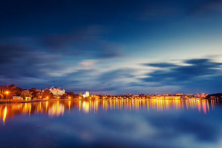 City at night with reflection in water. Ternopil, Ukraine, Europe. Beauty world.