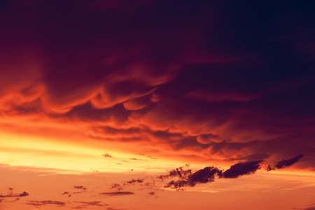 Beautiful nature background. Fantastic colorful sunset and dark ominous clouds. Beauty world.