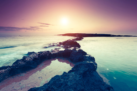 Amazing morning sun over the sea. Volcanic island of Malta. Qawra, Europe. Beauty world. Retro...