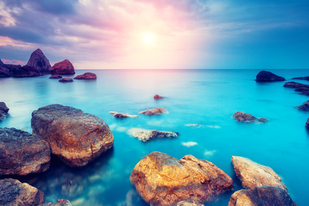 Fantastic morning blue sea glowing by sunlight. Dramatic scene. Black Sea, Crimea, Ukraine, Europe. Beauty world. Retro style filter. Fantastic morning blue sea glowing by sunlight. Dramatic scene. Black Sea, Crimea, Ukraine, Europe. Beauty world. Retro style filter.