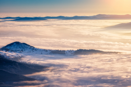 Mountain range glowing by warm sunlight at twilight. View from ski resort Dragobrat. Dramatic morning scene in Carpathian, Ukraineの写真素材