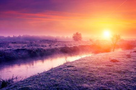 Majestic foggy river with fresh green grass in the sunlight. Dramatic colorful scenery in Dnister river, Ternopil. Ukraineの写真素材