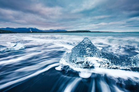 Great view of the ice fragments on black sand. Popular tourist attraction. Dramatic and picturesque scene. Location place Vatnajokull national park, Jokulsarlon lagoon, Iceland, Europe. Beauty world.の写真素材