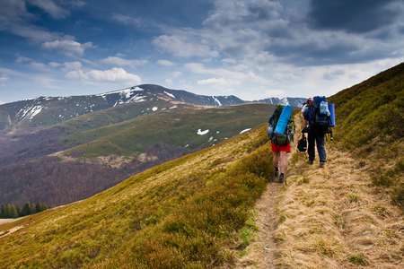 Hikers on Beautiful mountains landscape and cloudy skyの写真素材