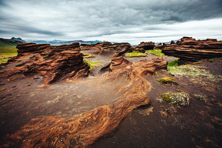 Sandy rocks with by magma formed by winds. Popular tourist attraction. Unusual and gorgeous scene. Location Sudurland, cape Dyrholaey, south coast of Iceland, Europe. Artistic picture. Beauty world.の写真素材
