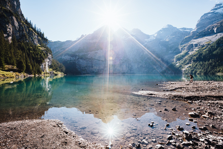 Panorama of the azure pond Oeschinensee. Popular tourist attraction. Picturesque and gorgeous scene. Location Swiss alps, Kandersteg, Bernese Oberland, Europe.の写真素材