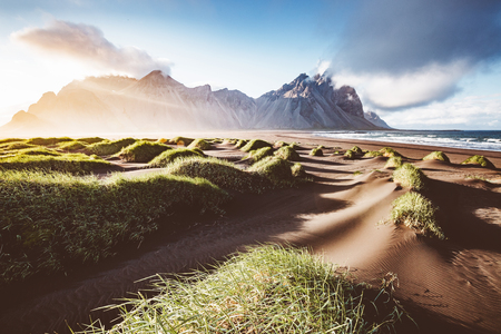 Unusual hills glowing by sunlight. Dramatic and gorgeous scene. Tourist attraction. Location Stokksnes cape, Vestrahorn (Mt. Batman), Iceland, Europe.の写真素材
