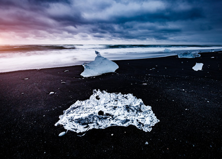 Large pieces of the iceberg that sparkle on the black sand. Popular tourist attraction. Location...