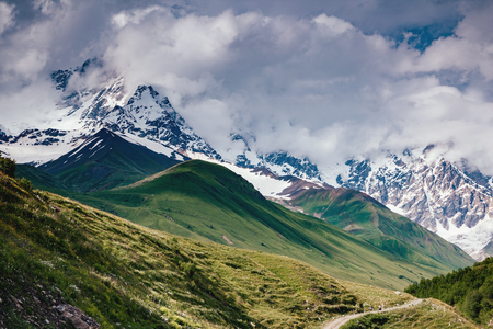 Fantastic range in mist at the foot Shkhara. Dramatic foggy scene. Location place Svaneti, Mestia, Georgiaの写真素材