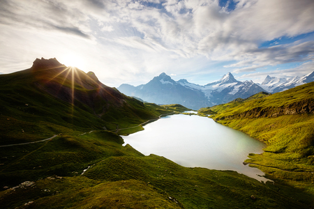 Panorama of the Bernese range in sunlight. Popular tourist attraction. Dramatic and picturesque scene. Location place Bachalpsee in Swiss alps, Grindelwald, Europe.の写真素材
