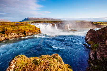 Nice views of the bright sunlit powerful Godafoss cascade. Popular tourist attraction. Unusual and picturesque scene. Location Bardardalur valley, Skjalfandafljot river, Iceland, Europe. Beauty world.の写真素材