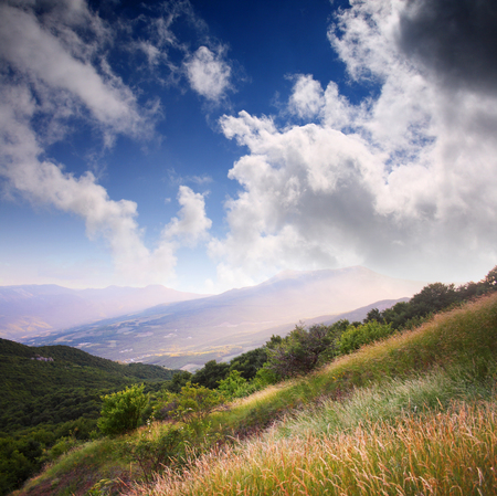 Landscape with mountains and cloudy skyの写真素材