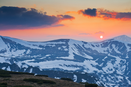 Landscape with mountains under evening sky with cloudsの写真素材