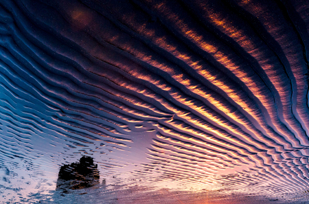 Black wavy sand pattern lit by sunlight. Picturesque and gorgeous scene. Beauty world.の写真素材