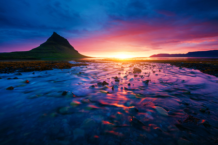 Evening Kirkjufell volcano the coast of Snaefellsnes peninsula. Location place Kirkjufellsfoss. Typical Icelandic landscape. Climate change. Wonderful image of wallpaper. Explore the world's beauty.の写真素材