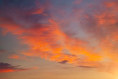 Perfect red vivid clouds illuminated by the beams of the sun. Scenic image of textured sky. Ecology concept - climate change in the environment. Picturesque wallpaper. Discover the beauty of earth.の写真素材