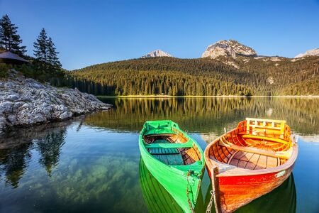 Amazing view of Black lake and wooden boats. Location National park Durmitor, Montenegro, Balkans, Europe. Scenic image of exotic nature landscape. Splendid summer scene. Discover the beauty of earth.の写真素材