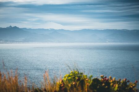 Breathtaking view of snowy mountain Etna. Location cape Milazzo, Sicily, region of Italy, Europe. Mediterranean resort. Scenic image of beautiful spring seascape. Discover the beauty of earth.の写真素材
