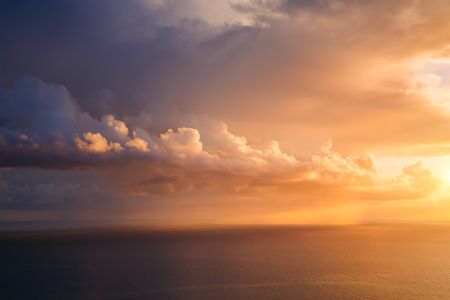 Unusual vivid clouds illuminated by the beams of the sun. Scenic image of textured sky. Ecology...