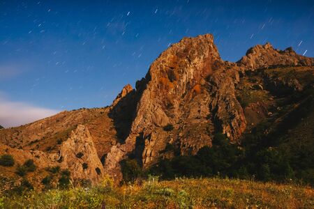 Fantastic starry sky over the mountain range. Dramatic and gorgeous scene. Location Crimea. Astrophotography. Scenic image of beautiful nature landscape, amazing view. Discover the beauty of earth.の写真素材