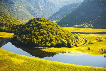 The magical valley of the Rijeka Crnojevica on a sunny day. Location place National park Skadar Lake, Montenegro, Balkans, Europe. Scenic image of the exotic summer scene. Explore the beauty of earth.の写真素材