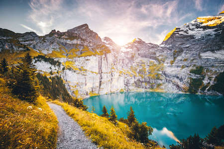 Idyllic panorama view of the lake Oeschinensee in day. Location place Swiss alps, Kandersteg, Bernese Oberland, Europe. Scenic image of most popular tourist attraction. Discover the beauty of earth.の写真素材