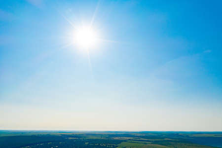 Shining sun at clear blue sky. Beautiful natural wallpaper. Sky background in the fresh sunny day....