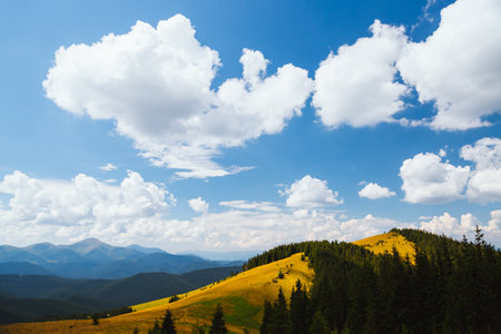 Azure sky background with white fluffy clouds in the sunny day. Location place Carpathian mountains,...