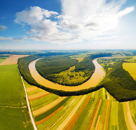 Horseshoe-shaped meander of the Dniester River from a bird's eye view. Location place Dnister canyon of Ukraine, Europe. Aerial photography, drone shot. Photo wallpaper. Discover the beauty of earth.の写真素材