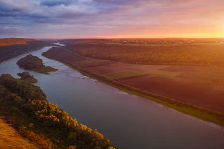 Beautiful top view of winding river in sunset. Scenic image of drone photography. Location place Dnister or Dniestr canyon, Ukraine, Europe. Picturesque wallpaper. Discover the beauty of earth.の写真素材