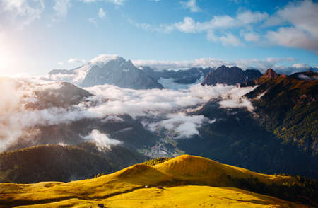 Thick fog covered the ridge in morning. Location place Val di Fassa valley. Scenic image of famous glacier Marmolada, passo Sella, Dolomiti, South Tyrol, Italy, Europe. Discover the beauty of world.の写真素材