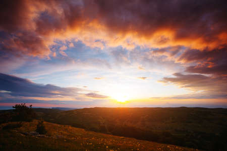 Perfect red clouds illuminated by the beams of the sun. Scenic image of textured sky. Photo of ecology concept. Natural wallpaper background. Epic sky in summer weather. Discover the beauty of earth.の写真素材