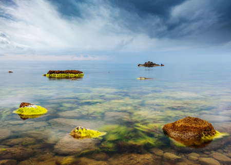 Idyllic view of the Black sea and huge stone blocks in the bay. Location place Crimea peninsula,...