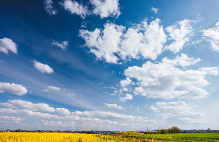 Blue sky background with white fluffy clouds in the fresh sunny day. Template textured sky...
