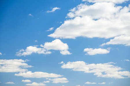 Blue sky background with white fluffy clouds in the fresh sunny day. Template textured sky background. Climate change, ecology concept. Photo of nature. Natural wallpaper. Beauty of earth.の写真素材