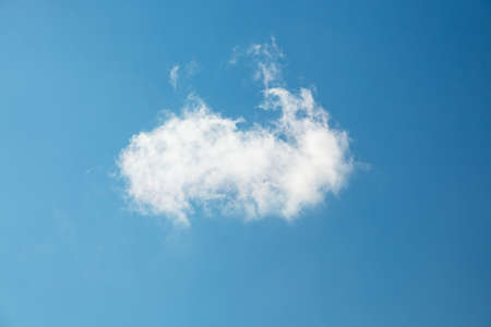 Single white cloud on blue sky background in daytime. Azure sky with white fluffy cloud in the fresh...