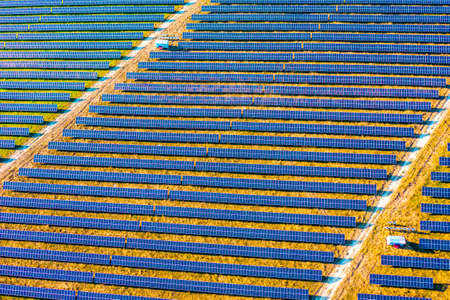 Top view on photovoltaic solar power panels. Alternative electricity source. Saving environment, save clean planet, ecology concept. Drone photography. Ukraine, Europe. Discover the beauty of earth.の写真素材