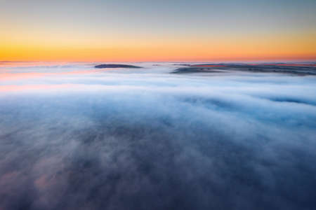 Agricultural lands are covered with thick fog in the morning. Location place Dniester canyon of Ukraine, Europe. Aerial photography, drone shot. Vibrant photo wallpaper. Discover the beauty of earth.の写真素材