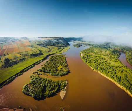 Attractive bird's eye view of the Dniester river with small islands. Location place Dnister canyon of Ukraine, Europe. Aerial photography, drone shot. Photo wallpaper. Discover the beauty of earth.の写真素材