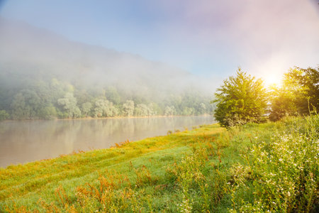 A thick fog covered the Dniester River in the morning. Location place Dnister canyon of Ukraine, Europe. Picturesque photo wallpaper. Splendid nature photography. Discover the beauty of earth.の写真素材
