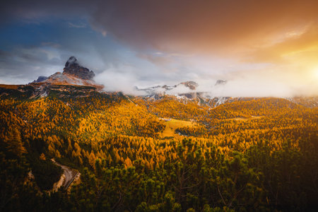 Magical top view of autumn forest in mountain valley. Location place National Park Tre Cime di...