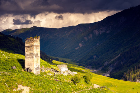 Ruins of a stone tower in the alpine village of Adishi. Famous tourist attraction. Location place Upper Svaneti, Georgia, Europe. Caucasus mountains. Photo wallpaper. Discover the beauty of earth.の写真素材
