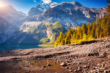 Summer view of the lake Oeschinensee in sunny day. Location Switzerland, Kandersteg district, Europe. picturesque photo wallpaper. Image of popular tourist destination. Discover the beauty of earth.の写真素材
