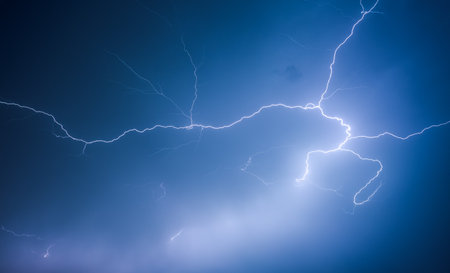 A strong storm with bright lightning illuminating ominous clouds. Exotic image of cloud texture. Adverse weather conditions. photo wallpaper. climate change. force of nature. beauty of earth.の写真素材