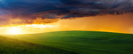 Spectacular storm clouds over the agricultural land in the evening. Agrarian region of Ukraine, Europe. force of nature. picturesque photo wallpaper. Concept of agrarian industry. beauty of earth.の写真素材