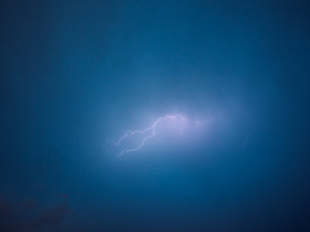A strong storm with bright lightning illuminating ominous clouds. Exotic image of cloud texture. Adverse weather conditions. photo wallpaper. climate change. force of nature. beauty of earth.の写真素材